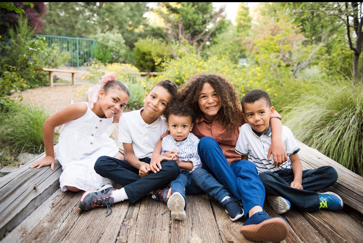 Romeo Brooks' grandchildren sitting together outdoors